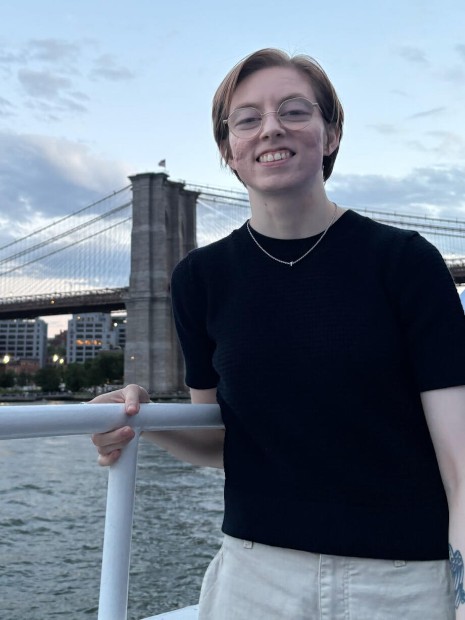 Lauren Brendle seated outdoors with the Manhattan skyline behind her